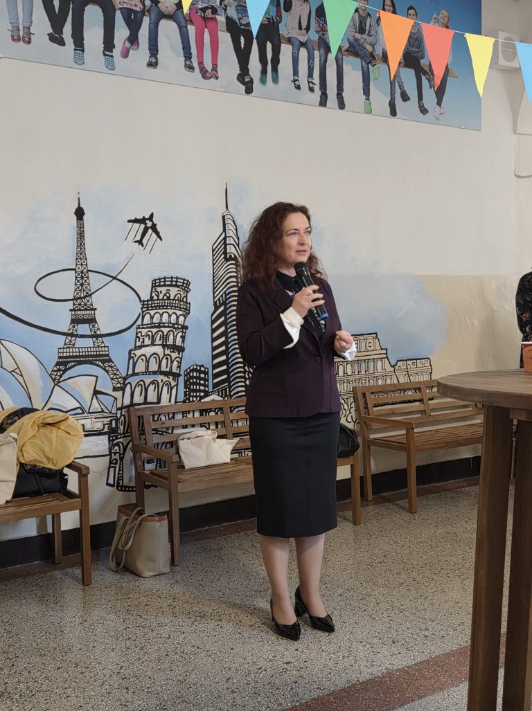 Generálna riaditeľka NIVaM Romana Kanovská stojí vpredu s mikrofónom, do ktorého rozpráva.